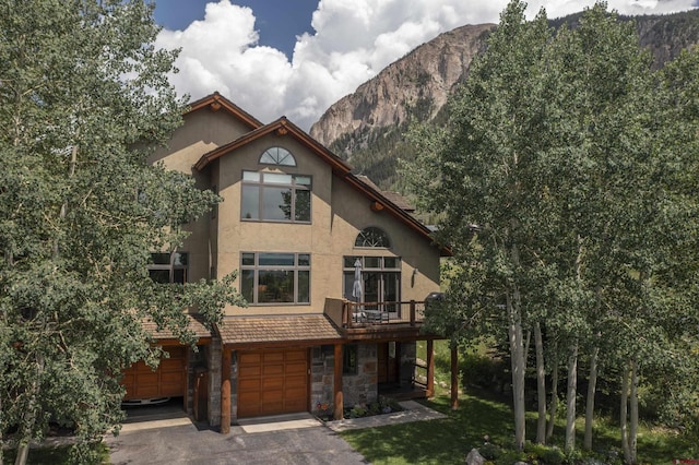 view of front of home with a mountain view and a garage