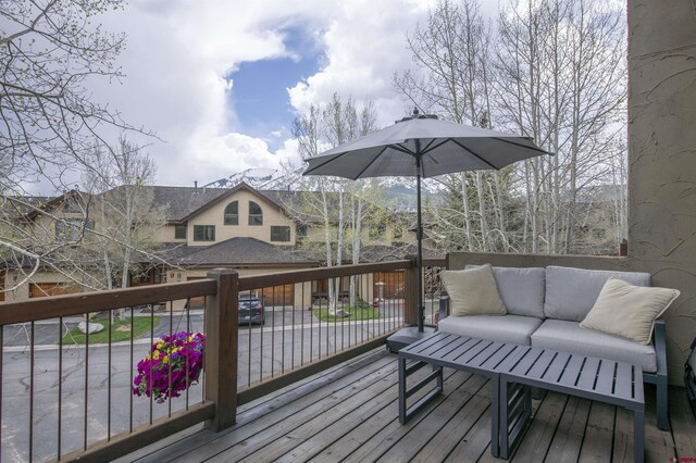 wooden terrace featuring an outdoor living space