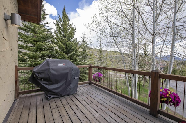 wooden deck with a grill