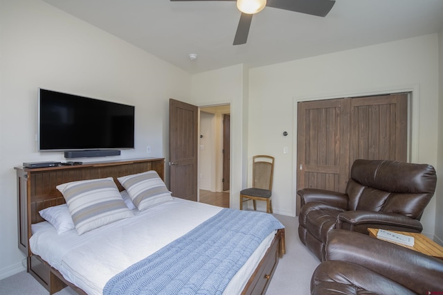 bedroom featuring ceiling fan, light colored carpet, and a closet