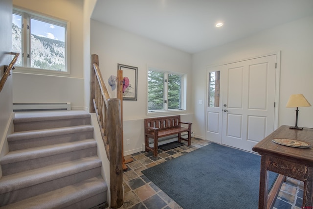 foyer with a wealth of natural light and a baseboard radiator