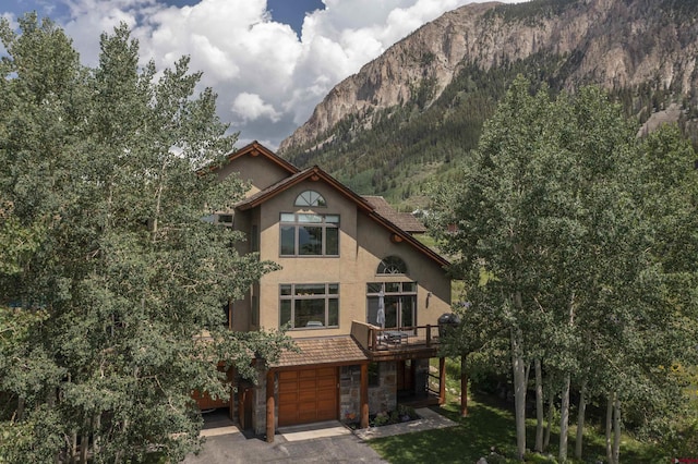 view of front facade with a mountain view and a garage