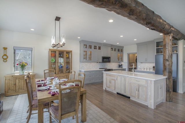 dining space with sink and hardwood / wood-style flooring