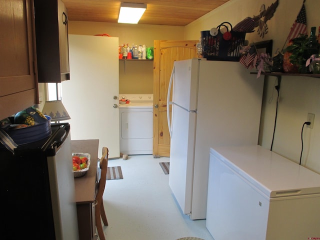 kitchen with white refrigerator, fridge, and washer / dryer