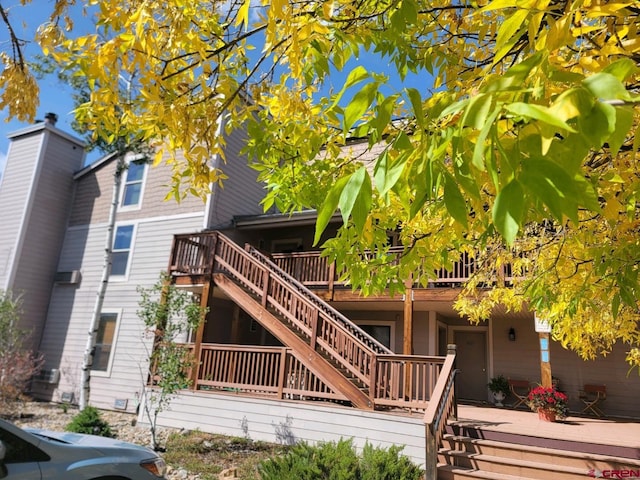 rear view of property featuring a deck