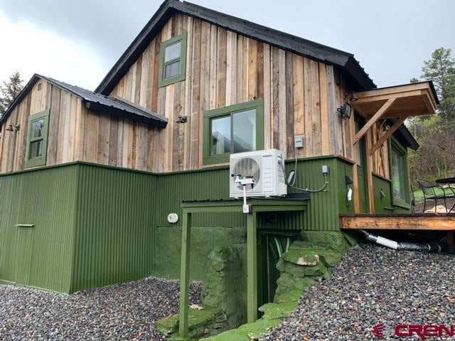 view of property exterior with a wooden deck