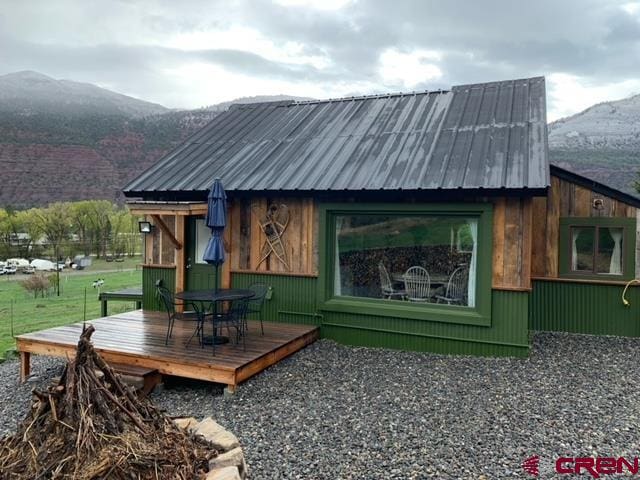 surrounding community featuring a deck with mountain view