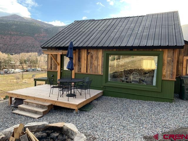 exterior space featuring an outdoor structure and a deck with mountain view