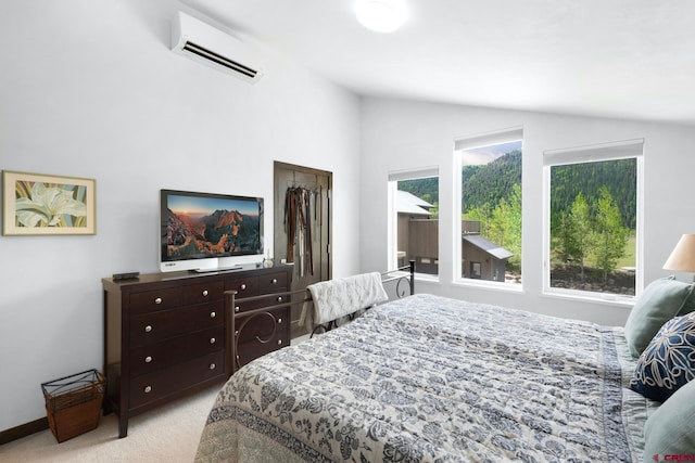 bedroom featuring light colored carpet, a closet, an AC wall unit, and lofted ceiling