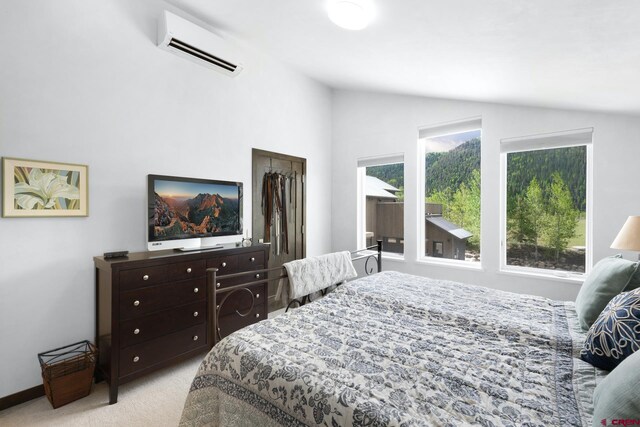 bedroom featuring carpet flooring, an AC wall unit, and lofted ceiling