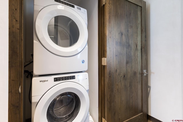 clothes washing area with laundry area and stacked washer and clothes dryer