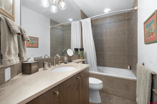 full bathroom with tile floors, vanity, toilet, and shower / bathtub combination with curtain