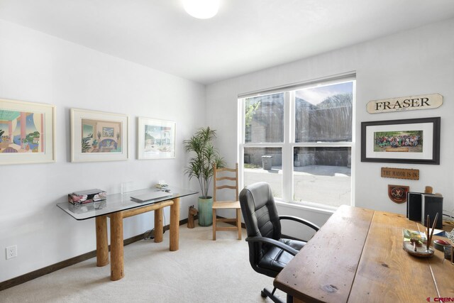 office area with baseboards, a healthy amount of sunlight, and carpet flooring