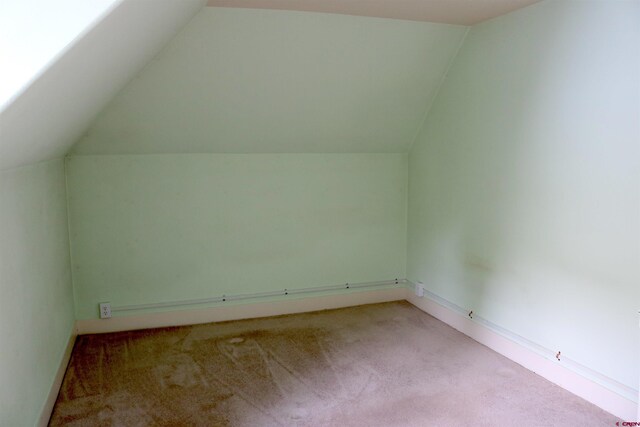 bonus room with carpet floors and lofted ceiling