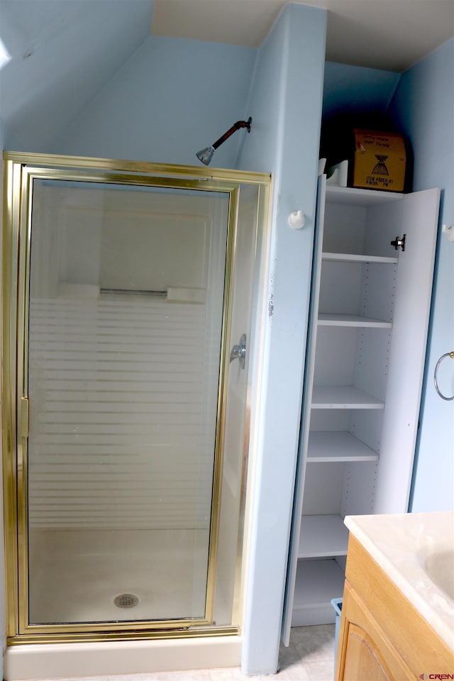 bathroom featuring an enclosed shower and vanity