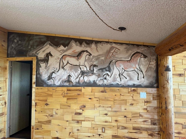 interior details featuring a textured ceiling and wooden walls