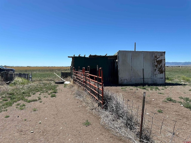 view of shed / structure featuring a rural view