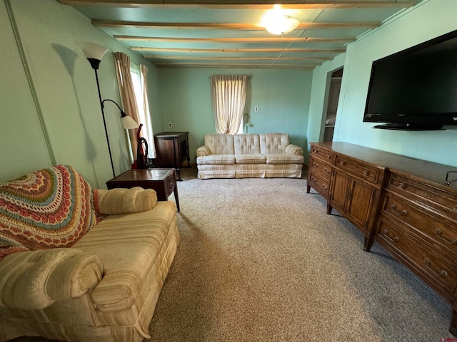 living room featuring beamed ceiling and carpet floors