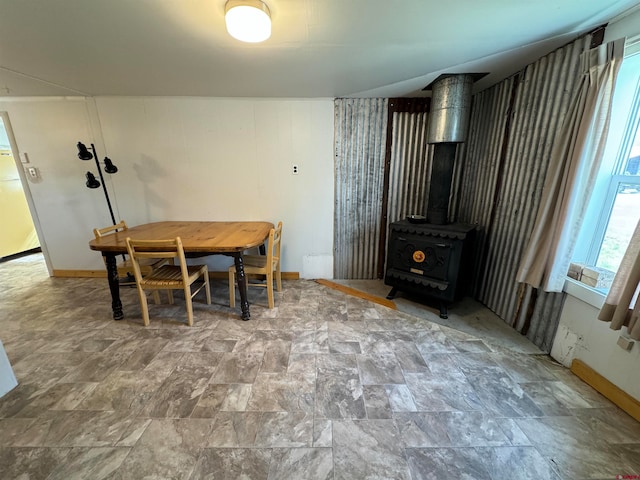 tiled dining room with a wood stove