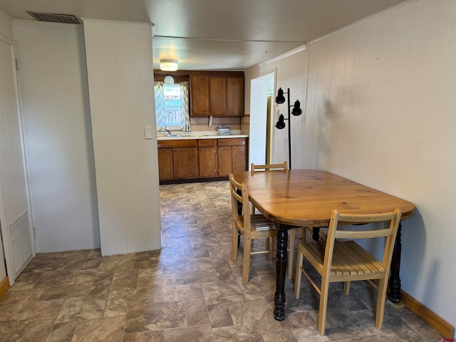 unfurnished dining area with sink and tile floors