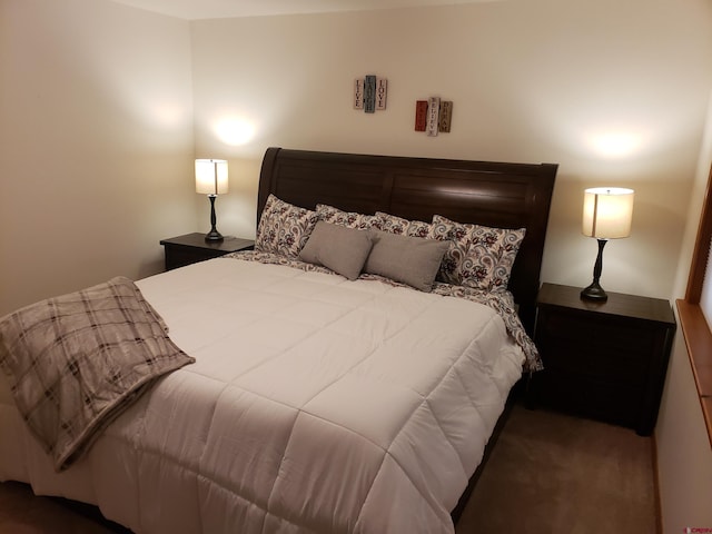 bedroom featuring dark carpet