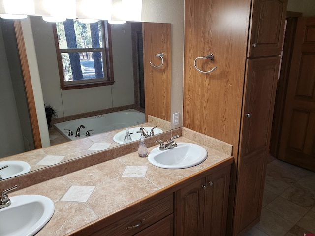 bathroom featuring tile patterned flooring, vanity, and a bath