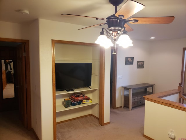 carpeted living room with ceiling fan