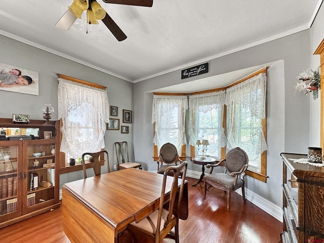 dining room featuring hardwood / wood-style flooring, ceiling fan, and crown molding