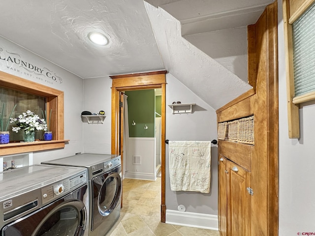 washroom featuring washer and clothes dryer and a textured ceiling