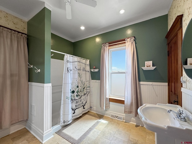 bathroom with ceiling fan, crown molding, and a shower with shower curtain