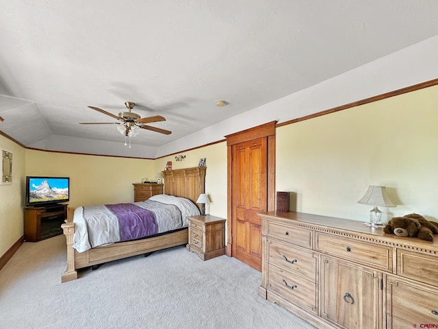 bedroom with ceiling fan, light colored carpet, and vaulted ceiling