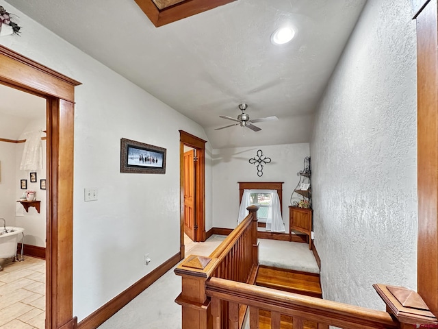 staircase featuring ceiling fan and lofted ceiling