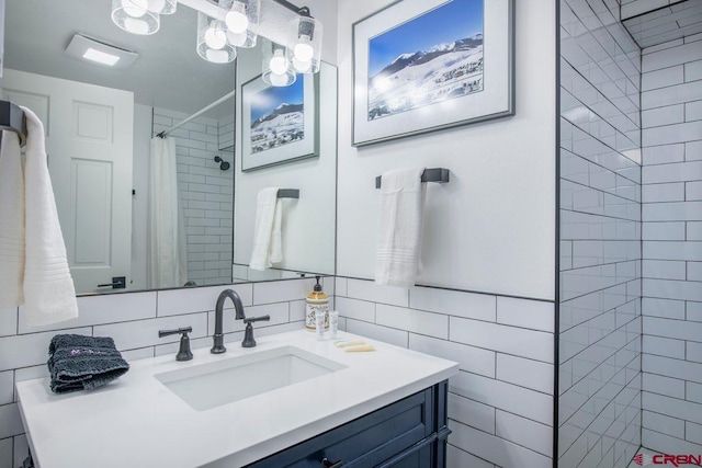 bathroom with vanity, a shower with curtain, and tile walls