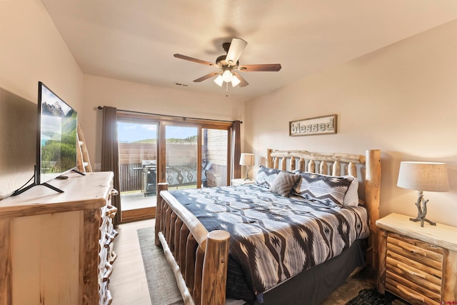 bedroom with hardwood / wood-style flooring, ceiling fan, and access to exterior