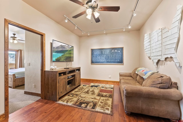 living room with track lighting, hardwood / wood-style flooring, and ceiling fan