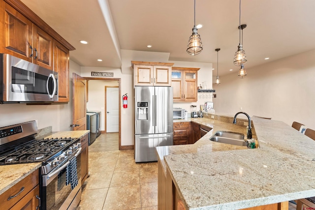 kitchen featuring kitchen peninsula, stainless steel appliances, light tile flooring, hanging light fixtures, and sink