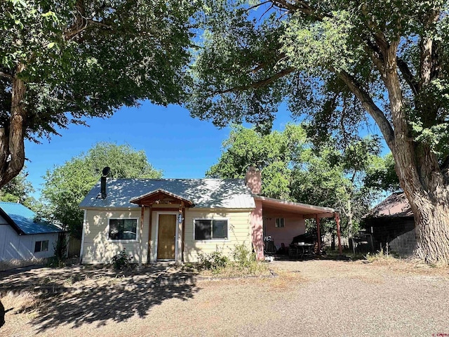 view of front of property featuring a carport