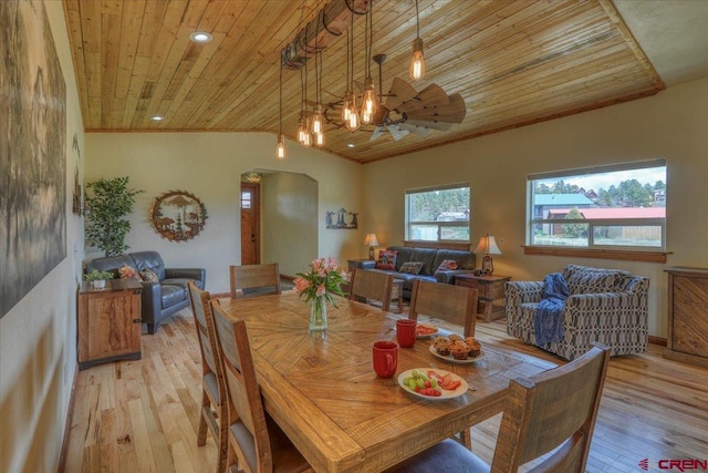 dining space featuring vaulted ceiling, light hardwood / wood-style floors, and wooden ceiling