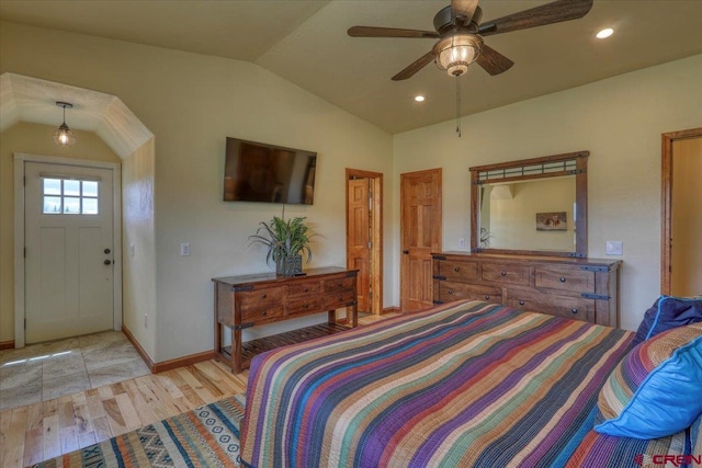 bedroom with lofted ceiling, light hardwood / wood-style flooring, and ceiling fan