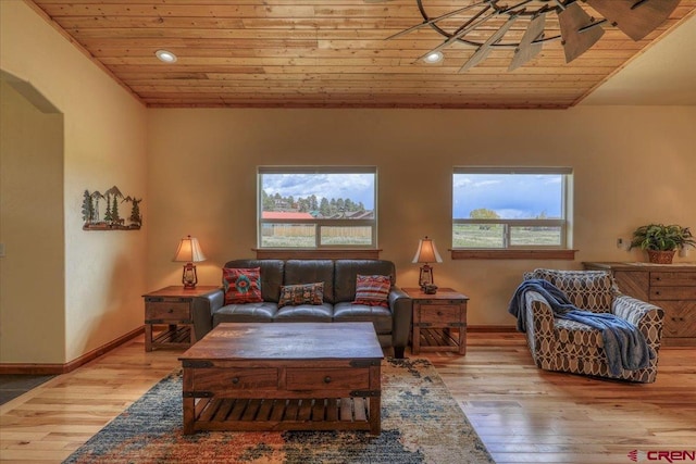 living room featuring plenty of natural light, light hardwood / wood-style flooring, and wooden ceiling