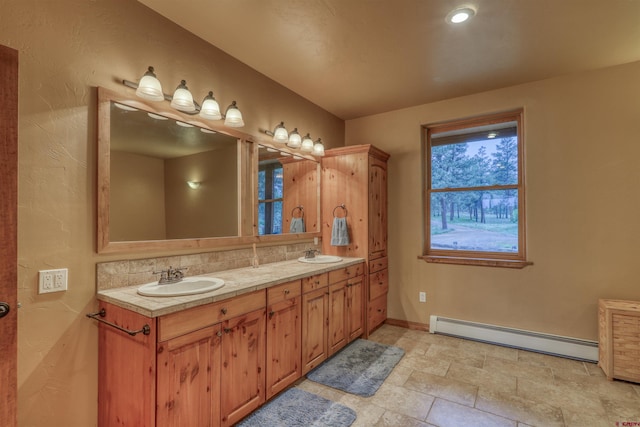 bathroom with vanity and baseboard heating