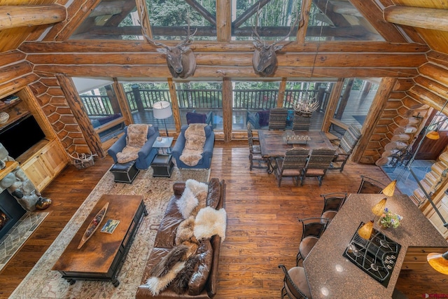47 High Noon Ln, Telluride, CO 81435 - living room featuring dark wood finished floors, log walls, high vaulted ceiling, and a wooden ceiling with exposed beams