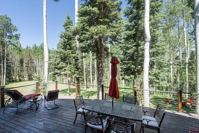 47 High Noon Ln, Telluride, CO 81435 - wooden terrace featuring outdoor dining space and a view of trees