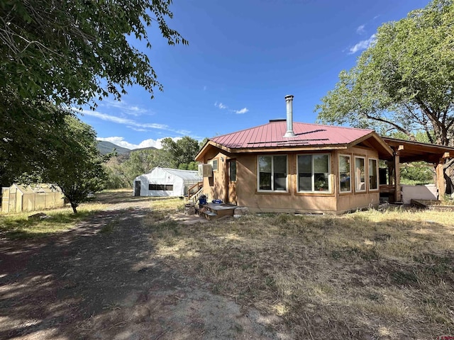 back of house with a mountain view