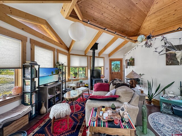 living room featuring lofted ceiling with beams, a wood stove, and dark wood-type flooring