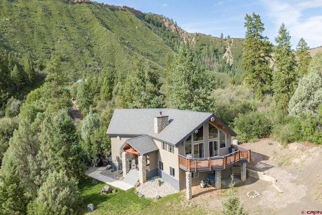 back of house with a deck with mountain view