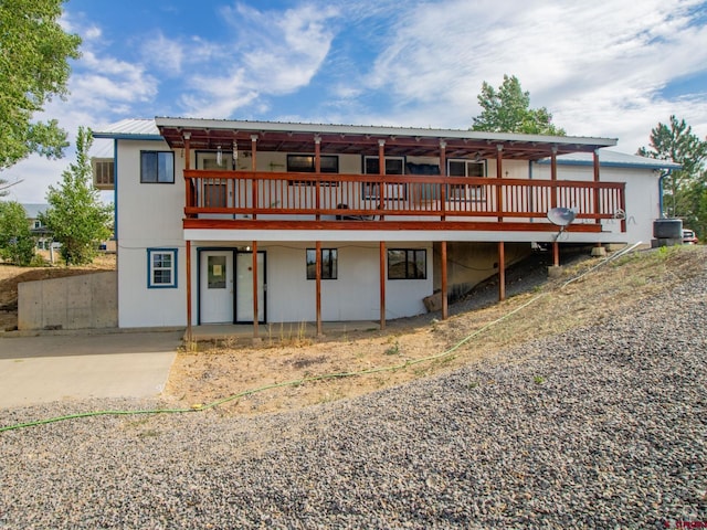 back of property featuring a deck