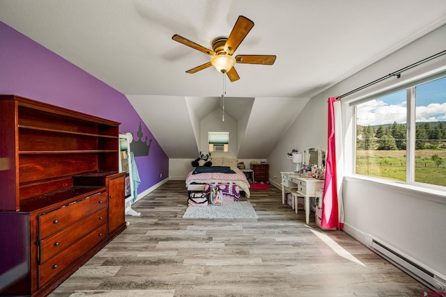 bedroom with wood finished floors, baseboards, lofted ceiling, ceiling fan, and baseboard heating