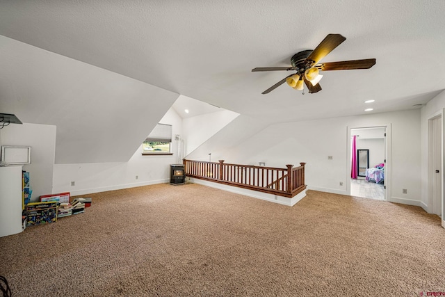 bonus room featuring a textured ceiling, lofted ceiling, and carpet floors