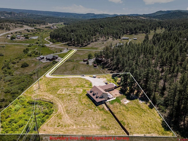 aerial view featuring a mountain view and a forest view